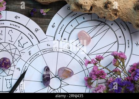 Flat lay composition with zodiac wheels and astrology dices on wooden table Stock Photo