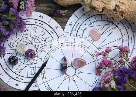 Flat lay composition with zodiac wheels and astrology dices on wooden table Stock Photo