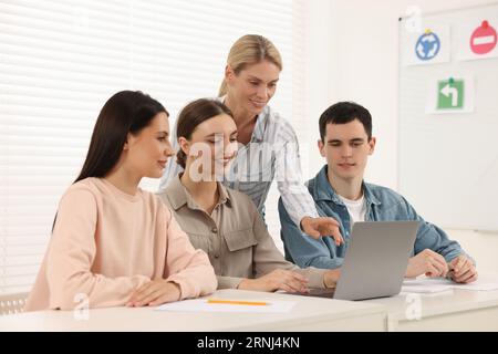 Happy teacher giving lesson in driving school Stock Photo