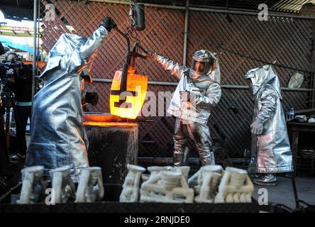 (170117) -- BURBANK, Jan. 17, 2017 -- Workers prepare to pour molten bronze into molds during the production process of casting the bronze statuette for the 23rd annual Screen Actors Guild (SAG) Awards in Burbank, California, the United States, on Jan 17, 2017. The statuette, known as The Actor , was originally designed by Jim Heimann and Jim Barrett, and sculpted by Edward Saenz. It is 16 inches (40.6 cm) tall and weighs 12 pounds (5.4 kg). Since the 1st SAG Awards in 1995, the statuettes have been produced by the American Fine Arts Foundry in Burbank. The American Fine Arts Foundry has made Stock Photo