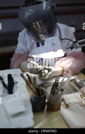 (170329) -- GIZA, March 29, 2017 -- An archaeologist works on parts of the second solar boat of Pharaoh Khufu at the restoration laboratory located in Giza, Egypt on March 29, 2017. Egypt opened its largest on-site antiquities laboratory to restore Pharaoh Khufu s second solar boat. King Khufu was a famous fourth dynasty Pharaoh who built the great Khufu Pyramid. His solar boat was designed to ferry him to the afterlife according to ancient Egyptian beliefs. The second solar boat of King Khufu was detected in 1987 in a large pit to the west of the first solar boat. Both boats lie on the southe Stock Photo