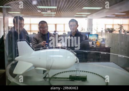 (170401) -- LIU AN, April 1, 2017 -- Designers discuss details in front of a captive balloon model at the 38th Research Institute of China Electronics Technology Group Corporation in Hefei, capital of east China s Anhui Province, March 28, 2017. The captive balloon is an air platform carrying various devices, such as warning radar, video surveillance equipment, fog detection devices, communication relay devices and imaging equipment. The balloon is expected to play a role in precaution and detection, environmental surveillance, security and protection monitoring. ) (lfj) CHINA-ANHUI-CAPTIVE BA Stock Photo