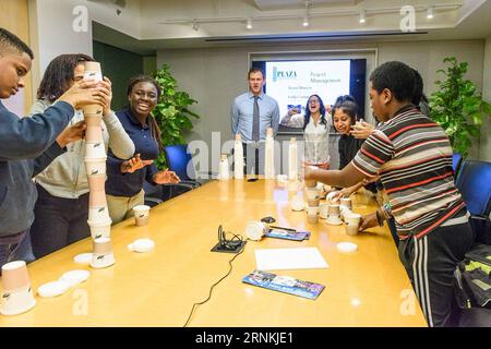 (170405) -- NEW YORK, April 5, 2017 () -- Teenagers learn basic construction knowledge by enjoying a cup-building game at the building of China State Construction Engineering Corporation in New York, the United States, on Feb. 25, 2016. Apart from the contributions to the local economy and job opportunities, Chinese enterprises have made continuous efforts in education projects, charity events and community works in the United States in the past years. () (gl) U.S.-CHINESE ENTERPRISE Xinhua PUBLICATIONxNOTxINxCHN   New York April 5 2017 Teenagers Learn Basic Construction Knowledge by enjoying Stock Photo