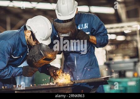 welding worker team working arc weld metal joint production in heavy industry danger and risk workplace with eyes safety equipment Stock Photo