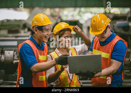 happy laugh engineer man and woman team enjoy working together talking using laptop computer Stock Photo