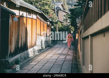 quiet alley in Kyoto Gion district with Japanese Kimono woman walking, Japan ancient way of life Stock Photo