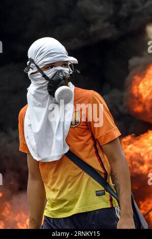 (170425) -- CARACAS, April 25, 2017 -- A demonstrator takes part in a protest in Caracas, Venezuela, on April 24, 2017. Venezuelan Foreign Minister Delcy Rodriguez on Saturday called for true and accessible global media coverage of the recent situation in the country. Since April 1, Venezuela has seen intense protests by both government and opposition supporters in Caracas and across the country, which have claimed at least 15 lives. Boris Vergara) (da) (rtg) (yy) VENEZUELA-CARACAS-PROTEST e BorisxVergara PUBLICATIONxNOTxINxCHN   Caracas April 25 2017 a demonstrator Takes Part in a Protest in Stock Photo