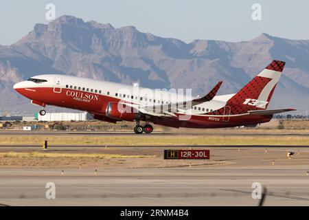 A Boeing 737 airtanker takes off with a load of retardant to fight a wildfire.  This plane was originally flown by Southwest Airlines. Stock Photo