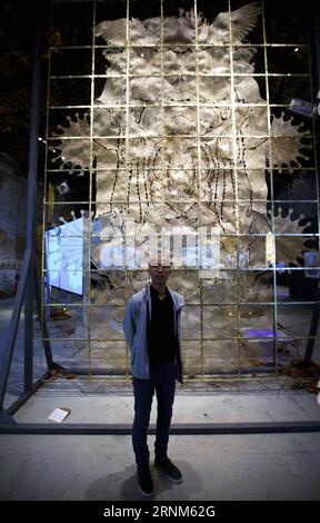 (170512) -- VENICE, May 12, 2017 -- Artist Wu Jian an poses for a photo with his work The Heaven of Nine Levels at the Chinese Pavilion during the 57th International Art Exhibition (57th Venice Biennale) in Venice, Italy, on May 11, 2017. The Chinese Pavilion opened to the public on Thursday. Curated by Professor Qiu Zhijie from School of Experimental Art of China Central Academy of Fine Arts (CAFA), the exhibition shows the artwork of four artists, Tang Nannan, Wu Jian an, Yao huifen and Wang Tianwen, presenting the theme of Continuum-Generation by Generation . ) (zy) ITALY-VENICE-BIENNALE-CH Stock Photo