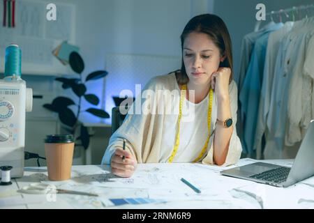 artisit designer hard working at night for sketch crafting creative fashion costume design Stock Photo