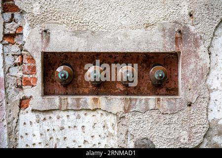 Ceramic insulators on old transformer building wall in Mathildedal, Perniö, Finland Stock Photo