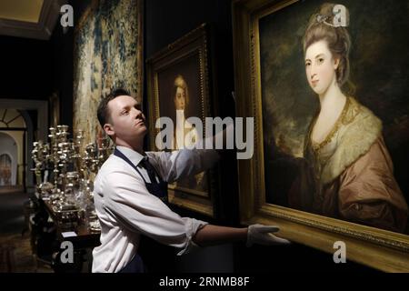 (170520) -- LONDON, May 20, 2017 -- A Sotheby s staff member adjusts a painting titled Portrait of Mrs Richard-Pennant by artist Sir Joshua Reynolds, from the Belgravia home of Lord Ballyedmond presented in the Sotheby s auction house sale which recalls the aristocratic London town house in London, Britain on May 19, 2017. ) (gj) BRITAIN-LONDON-SOTHEBY S-THE BALLYEDMOND COLLECTION RayxTang PUBLICATIONxNOTxINxCHN   London May 20 2017 a Sotheby S Staff member ADJUST a Painting titled Portrait of Mrs Richard Pennant by Artist Sir Joshua Reynolds from The Belgravia Home of Lord  presented in The S Stock Photo