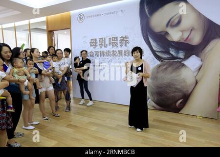 (170520) -- BEIJING, May 20, 2017 -- Song Dan (1st R) takes part in an event to promote breastfeeding at a department store in Beijing, capital of China, Aug. 6, 2016. Song Dan, a former IT engineer working for renowned Chinese IT firm Huawei, is now a senior lactagogue master, a profession to help new mothers to stimulate the secretion of milk through massage. Song started her brand new business five years ago when she had to face a choice between her IT engineer carrier and family. The advantage of flexible working time as lactagogue master made Song determine to give up her former job. She Stock Photo