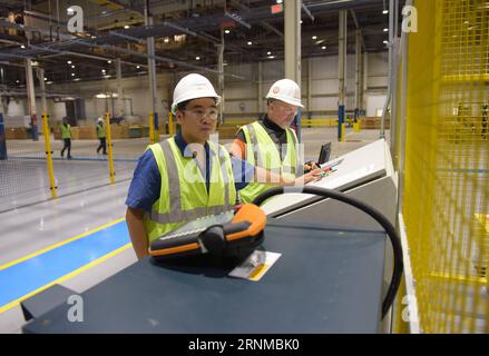 (170520) -- NEW YORK, May 20, 2017 -- File photo taken on Aug. 5, 2015 shows Ni Zhenghong from China (L) and David wigle working at a factory of Fuyao Glass America in Moraine, Ohio, the United States. Fuyao is one of the world s largest auto glass makers and has a 22-percent market share in the United States. Its investment in Moraine is the largest Chinese investment in Ohio history and the eighth-largest direct foreign investment in the United States over the last decade. More than 2,000 people are working at Fuyao s nearly 470,000-square-meter glass fabrication factory. Foreign Direct Inve Stock Photo