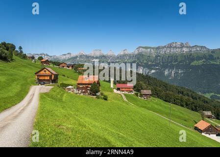 Farms on the Flumserberg, view towards the Churfirsten with Chaeserrugg, Canton St. Gallen, Switzerland Stock Photo