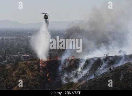 (170629) -- LOS ANGELES, June 29, 2017 -- A helicopter tries to extinguish a wildfire in Burbank, California, the United States, June 28, 2017. A wildfire broke out on a hillside in Burbank, prompting evacuations as the flames burned near homes. ) (jmmn) U.S.-LOS ANGELES-WILDFIRES NickxUt PUBLICATIONxNOTxINxCHN   Los Angeles June 29 2017 a Helicopter tries to extinguisher a wild in Burbank California The United States June 28 2017 a wild Broke out ON a Hillside in Burbank prompting Evacuations As The Flames burned Near Homes jmmn U S Los Angeles wildfires  PUBLICATIONxNOTxINxCHN Stock Photo