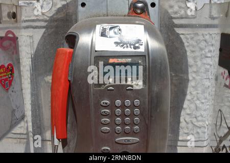 An old public phone works with coins and phone cards in the streets of the historic center. By the end of 2023, the Italian TIM will remove them . Stock Photo