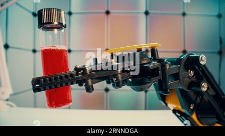 a robot holds a sample of a chemical substance the concept of using robotics in laboratory work Stock Photo