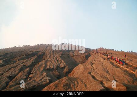 (170710) -- PROBOLINGGO, July 10, 2017 -- People hike to watch offerings thrown in Mount Bromo during the traditional Kasada festival in Probolinggo, East Java, Indonesia, July 10, 2017. Hindu worshipers gave offerings to the God of Mount Bromo by throwing rice, fruits, flowers and livestock into the volcano s caldera, in a good wish for harvest and good fortune. ) (zcc) INDONESIA-PROBOLINGGO-KASADA FESTIVAL Kurniawan PUBLICATIONxNOTxINxCHN   Probolinggo July 10 2017 Celebrities hike to Watch offerings thrown in Mount Bromo during The Traditional Kasada Festival in Probolinggo East Java Indone Stock Photo