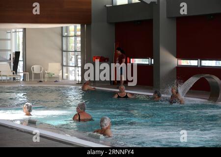 (170712) -- LOUTRAKI (GREECE), July 12, 2017 -- Photo taken on June 19, 2017 shows that people bathe in Loutraki Thermal Spa at the seaside resort of Loutraki, 80 km southwest of Athens, capital of Greece. A breath away from Athens, the seaside resort of Loutraki on the Gulf of Corinth has been for several decades a popular holiday destination for those seeking to take a dive in history, the sea and the therapeutic waters of the natural thermal springs at the foot of Geraneia mountain range. Amid the acute debt crisis that has hit Greece since 2009, local authorities in this town of 20,000 inh Stock Photo