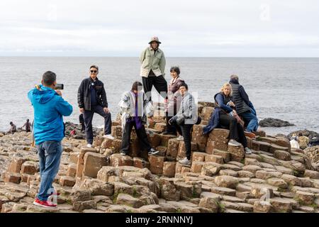 Giant's Causeway, near Bushmills, northern Ireland. Visitors to the natural basalt rock formations, which are a popular tourist attraction. Stock Photo