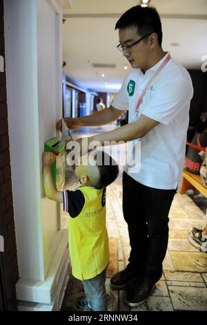 (170729) -- BEIJING, July 29, 2017 -- A boy suffering autism is helped by a volunteer to send a letter during an interactive game in a campaign to show love to the autistic children in Beijing July 29, 2017. ) (clq) CHINA-BEIJING-AUTISTIC CHILDREN-CARE(CN) RenxPengfei PUBLICATIONxNOTxINxCHN   Beijing July 29 2017 a Boy Suffering Autism IS helped by a Volunteer to Send a Letter during to Interactive Game in a Campaign to Show Love to The Autistic Children in Beijing July 29 2017 CLQ China Beijing Autistic Children Care CN RenxPengfei PUBLICATIONxNOTxINxCHN Stock Photo