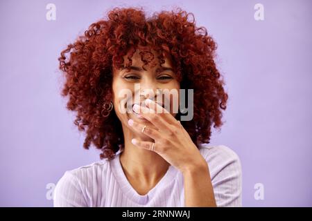 Hair, happy and portrait of woman laughing in studio for red, dye or afro makeover on purple background. Haircare, transformation or face of lady Stock Photo