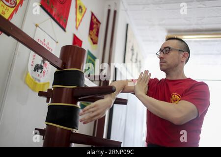 (170803) -- NEW YORK, Aug. 3, 2017 -- Alex Richter practices with the Wooden Dummy at his Kung Fu school City Wing Tsun in New York, the United States, July 17, 2017. Hidden in the midtown of bustling New York City is City Wing Tsun . This is Alex Richter s Kung Fu school which features, as the name suggests, Wing Tsun, a Hong-Kong style martial art. As a native-born American kid, Richter was hugely influenced by the martial art films star Bruce Lee. His love towards Kung Fu, especially Wing Tsun, which Bruce Lee learned as a teenager, has been with him ever since. Richter started to learn Win Stock Photo