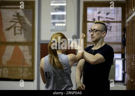 (170803) -- NEW YORK, Aug. 3, 2017 -- Alex Richter gives personal lesson to his student Xiaomai at his Kung Fu school City Wing Tsun in New York, the United States, July 12, 2017. Hidden in the midtown of bustling New York City is City Wing Tsun . This is Alex Richter s Kung Fu school which features, as the name suggests, Wing Tsun, a Hong-Kong style martial art. As a native-born American kid, Richter was hugely influenced by the martial art films star Bruce Lee. His love towards Kung Fu, especially Wing Tsun, which Bruce Lee learned as a teenager, has been with him ever since. Richter started Stock Photo