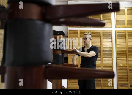 (170803) -- NEW YORK, Aug. 3, 2017 -- Alex Richter practices with the Wooden Dummy at his Kung Fu school City Wing Tsun in New York, the United States, July 12, 2017. Hidden in the midtown of bustling New York City is City Wing Tsun . This is Alex Richter s Kung Fu school which features, as the name suggests, Wing Tsun, a Hong-Kong style martial art. As a native-born American kid, Richter was hugely influenced by the martial art films star Bruce Lee. His love towards Kung Fu, especially Wing Tsun, which Bruce Lee learned as a teenager, has been with him ever since. Richter started to learn Win Stock Photo