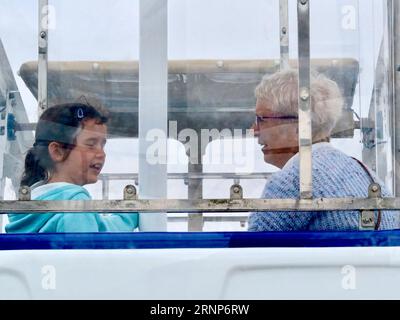 Felixstowe, Suffolk - 2 September 2023 : Riding on The View, a ferris wheel on the seafront near Mannings. Overcast Saturday afternoon. Granny, grandaughter. Stock Photo