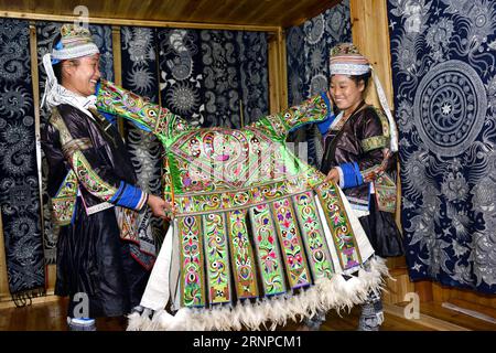 (170823) -- QIANDONGNAN, Aug. 23, 2017 -- Women of the Miao ethnic group show traditional hundred-bird clothing in Baibei Village of Rongjiang County, southwest China s Guizhou Province, Aug. 22, 2017. The hundred-bird clothing, embroidered with colorful silk and bird feathers, is the traditional dress for festivals and important occasions of Miao ethnic group. It takes local people several months to make a piece of hundred-bird clothing. )(mcg) CHINA-GUIZHOU-RONGJIANG-MIAO ETHNIC GROUP-COSTUME (CN) WangxBingzhen PUBLICATIONxNOTxINxCHN   Qiandongnan Aug 23 2017 Women of The Miao Ethnic Group S Stock Photo
