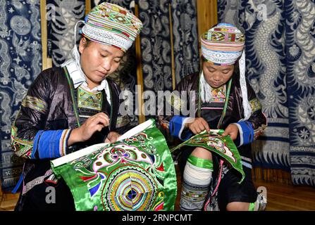 (170823) -- QIANDONGNAN, Aug. 23, 2017 -- Women embroider patterns on traditional hundred-bird clothing in Baibei Village of Rongjiang County, southwest China s Guizhou Province, Aug. 22, 2017. The hundred-bird clothing, embroidered with colorful silk and bird feathers, is the traditional dress for festivals and important occasions of Miao ethnic group. It takes local people several months to make a piece of hundred-bird clothing. )(mcg) CHINA-GUIZHOU-RONGJIANG-MIAO ETHNIC GROUP-COSTUME (CN) WangxBingzhen PUBLICATIONxNOTxINxCHN   Qiandongnan Aug 23 2017 Women embroider patterns ON Traditional Stock Photo