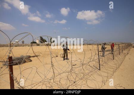(170824) -- GAZA, Aug. 24, 2017 -- Palestinian workers install barbed wires along the border with Egypt near the southern Gaza strip city Rafah on Aug. 24, 2017. Bordering Israel and the Palestinian Gaza Strip, Egypt s North Sinai province has been the center of anti-government terrorist attacks that killed hundreds of policemen and soldiers since the military removal of former Islamist president Mohamed Morsi in July 2013. ) (srb) MIDEAST-GAZA-SECURITY MEASURES KhaledxOmar PUBLICATIONxNOTxINxCHN   Gaza Aug 24 2017 PALESTINIAN Workers install Barbed wires Along The Border With Egypt Near The S Stock Photo