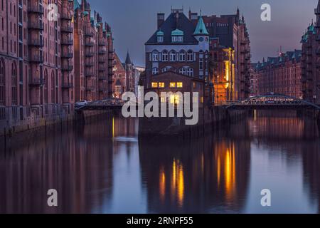 The City of Warehouses or the Speicherstadt with its main landmark, the Wasserschloss or the Watercastle. Photo taken on 8th of June 2023 in the UNESC Stock Photo