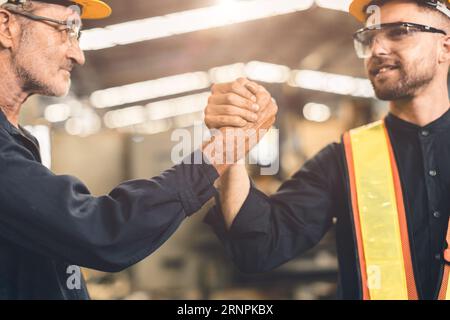 young engineer with senior team work happy joint hand force cooperate power working together Stock Photo