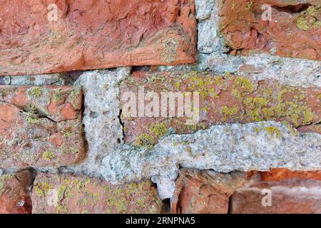 Ancient medieval red brick wall. wall texture background. The wall is partially collapsed. Stock Photo