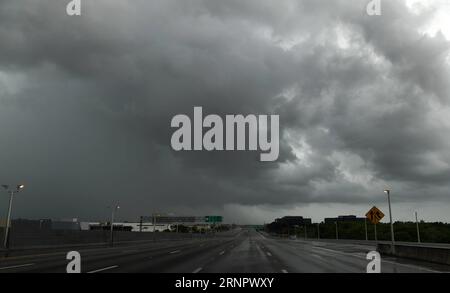 (170910) -- MIAMI, Sept. 10, 2017 -- An almost empty highway is seen under dark clouds as hurricane Irma is approaching, in Miami, Florida, the United States, Sept. 9, 2017. About 5.6 million people in Florida have been ordered to evacuate, while 54,000 Floridians have taken shelter in 320 shelters across Florida. Forecasters expect the hurricane to hit Florida early Sunday morning. ) (srb) U.S.-MIAMI-HURRICANE-IRMA-APPROACHING YinxBogu PUBLICATIONxNOTxINxCHN Stock Photo