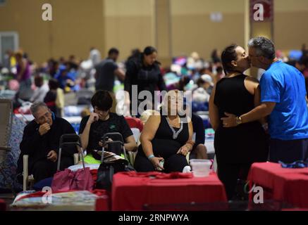 (170910) -- MIAMI, Sept. 10, 2017 -- People are seen at a shelter at the Miami-Dade County Fair Expo Center in Miami, as hurricane Irma is approaching, in Miami, Florida, the United States, Sept. 9, 2017. About 5.6 million people in Florida have been ordered to evacuate, while 54,000 Floridians have taken shelter in 320 shelters across Florida. Forecasters expect the hurricane to hit Florida early Sunday morning. ) (srb) U.S.-MIAMI-HURRICANE-IRMA-APPROACHING YinxBogu PUBLICATIONxNOTxINxCHN Stock Photo