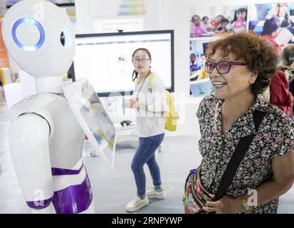 (170912) -- BEIJING, Sept. 12, 2017 -- A woman talks with a robot at the first China Beijing International Language & Culture Expo (ILCE) in Beijing, capital of China, Sept. 12, 2017. The first China Beijing ILCE would be held here from Sept. 11 to 13. )(wjq) CHINA-BEIJING-LANGUAGE & CULTURE EXPO (CN) ShenxBohan PUBLICATIONxNOTxINxCHN Stock Photo