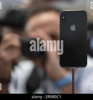 (170912) -- CUPERTINO (U.S.), Sept. 12, 2017 () -- A man takes photos of new iPhone X displayed during a special event in Cupertino, California, the United States on Sept. 12, 2017. Apple Inc. released a series of new products and services in Cupertino on Tuesday. () U.S.-CUPERTINO-APPLE-NEW PRODUCTS Xinhua PUBLICATIONxNOTxINxCHN Stock Photo