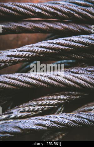 A full frame close up of strong metal cable used in shipping or construction that has been greased to protect from rust with copy space Stock Photo