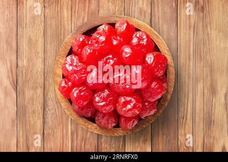 candied fruit, dried cherries with sugar in wooden bowl on  background of table. healthy vegetable food. Stock Photo