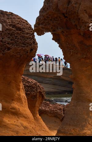 (171003) -- TAIPEI, Oct. 3, 2017 -- Tourists visit Yehliu Geopark in New Taipei of southeast China s Taiwan, Oct. 3, 2017. The geopark features stunning geological landscape formed by wave attack, rock weathering, earth movement and crustal movement, which make it a famous destination for tourists. ) (wjq) CHINA-NEW TAIPEI-YEHLIU GEOPARK (CN) ZhaoxYingquan PUBLICATIONxNOTxINxCHN Stock Photo