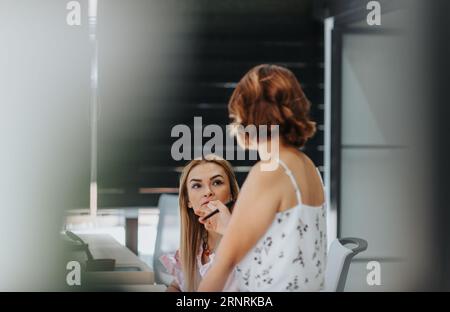 Start up team communicate, brainstorm, and use technology for analysis. Dedicated to innovation and growth, they ensure success for their start-up com Stock Photo