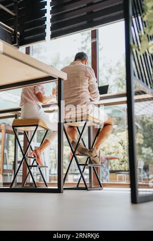 A diverse group of businesspeople working together in an office discussing project instructions and analyzing statistics for better results and corpor Stock Photo