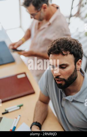 In a corporate office, businessmen and businesswomen work together analyzing data, discussing projects, and solving problems for successful business g Stock Photo