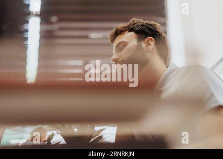 Handsome, young businessman analyzing, discussing, and collaborating in a diverse corporate office with innovative leaders and efficient teamwork. Stock Photo