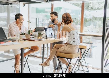 Successful Marketing Team Sharing Ideas and Working Together in Office. Stock Photo
