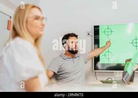 A diverse group of professionals in a modern indoor meeting, collaborating and brainstorming for business growth and efficiency. Stock Photo
